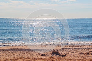 Sunlight reflecting on sparkling blue sea at Southwold beach in UK