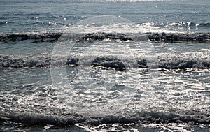 Sunlight reflecting of waves in the sea Bamburgh