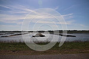 sunlight reflects on the water of the water storage and rowing course in Zevenhuizen near Rotterdam in the Netherlands