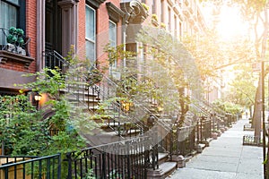 Sunlight shines on historic brownstone buildings in New York City