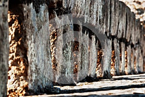 Sunlight streaming through slits in a wall