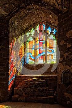 Sunlight streaming through a stained glass window, Goodrich Castle, Herefordshire.