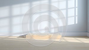 Sunlight streaming through a window casting geometric shadows on a floor and wall