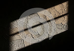 Sunlight streams through a window, casting shadows on a textured wall. The wall