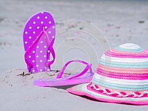 Sunlight Summer composition. Beach flip flops on tropical ocean sand. against blue sea and sky background. Beach Accessories