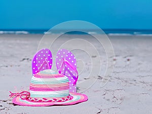 Sunlight Summer composition. Beach flip flops on tropical ocean sand. against blue sea and sky background. Beach Accessories