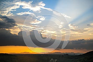 Sunlight and sunray over mountain in sunset