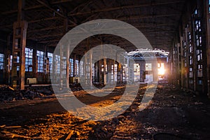 Sunlight of sunset in large abandoned industrial building of Voronezh excavator factory