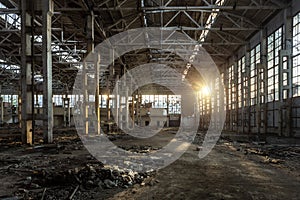 Sunlight of sunset in large abandoned industrial building of Voronezh excavator factory