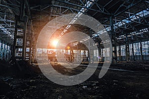 Sunlight of sunset in large abandoned industrial building of Voronezh excavator factory