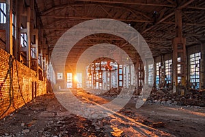 Sunlight of sunset in large abandoned industrial building of Voronezh excavator factory