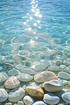 Sunlightbeams, Crystal Clear Water, underwater view showcasing Smooth Rocks on Ocean Floor. photo