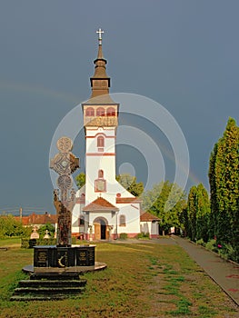 Orthodox assumption church with cross in front in ORastie, Romania photo