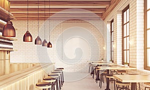 Sunlit bar interior with stools and poster