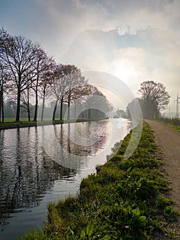 Sunlit Canal Path at Dawn