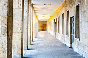 Sunlit Corridor With Columns and Doors