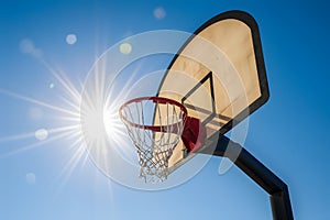 Sunlit outdoor basketball hoop exudes sportsmanship and energy