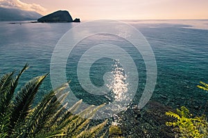 Sunlit path over Adriatic sea. Sun glare on the surface of the sea.