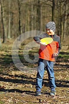 Sunlit portrait of a boy learning to play ultimate frisbee