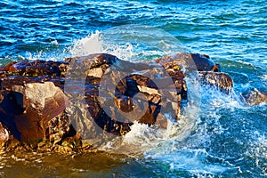 Sunlit Rocky Shore and Waves at Eagle Harbor