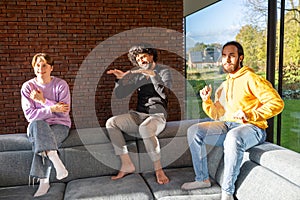 Three Friends Enjoying a Light-hearted Conversation on a Sofa photo