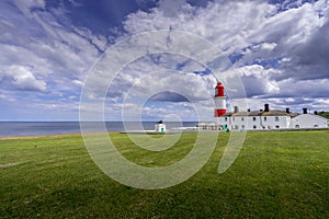 Sunlit Souther Lighthouse and Foxhorn building