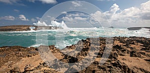 Sunlit storm surf waves crashing into Laie Point coastline at Kaawa on the North Shore of Oahu Hawaii USA