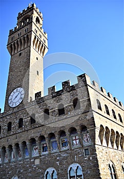 Sunlit wall and tower of Palazzo Vecchio, photographed from the terrace of the Uffizi museum in Florence.