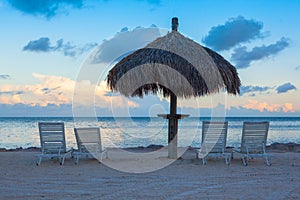 Sunlounge chairs and umbrella on the sunset beach in Florida Key photo
