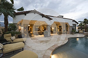 Sunloungers At Poolside Of Modern House