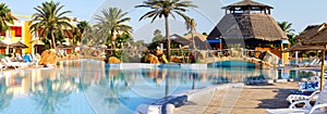 Sunloungers on swimming pool