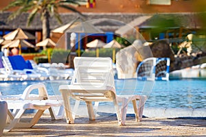 Sunloungers on swimming pool