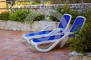 Sunloungers beside a swimming pool in a hotel