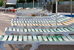 Sunloungers in a swimming pool terrace