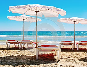 Sunloungers and umbrellas in a quiet beach photo