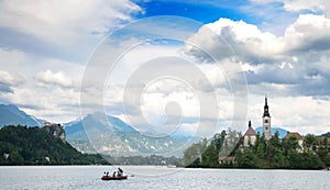 Sunning panoramic view of The island of Bled, Bled castle on cliff, Julian Alps and Church of the Assumption,Bled, Slovenia.