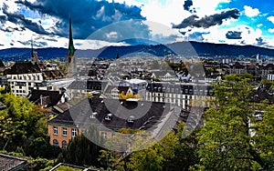 Sunny aerial zurich old town historic city centre university view over city church tower buildings trees background hill