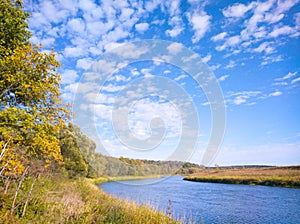 Sunny autumn day by the river bend in the countryside