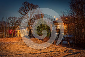 Sunny autumn landscape with dilapidated houses.n