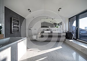 Sunny bathroom in modern style with different walls