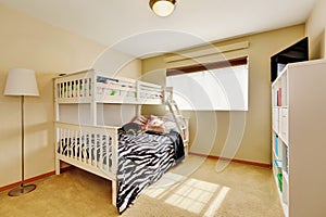 Sunny beige kids` room with bunk bed