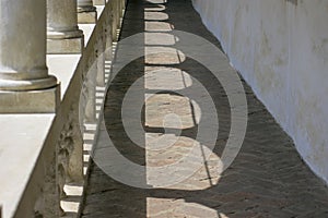 Sunny building corridor colonnade shadow pattern