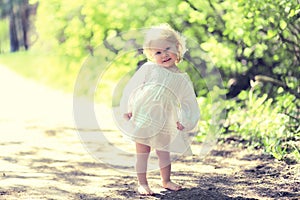 Sunny cute child barefoot in summer day