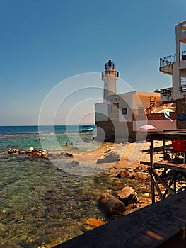 Sunny day at the beach near the coast of Tyr city also known as Sour In Lebanon Middle east ,see people swimming near lighthouse