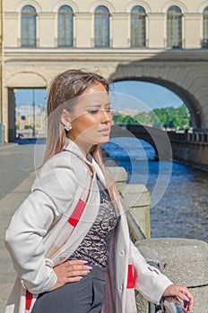 Sunny day, beautiful girl on the waterfront