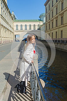 Sunny day, beautiful girl on the waterfront