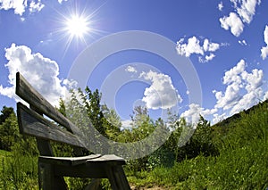 Sunny day fish eye photo of a park bench