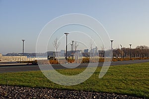 Sunny day with green grass and blue sky. Young trees. Reidi tee promenade. Modern space for walking and rest in a city