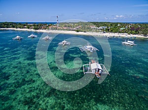 Sunny Day in Malapascua Island in Visayan Sea, One of Cebu Island. Sea water and Boats. Bounty Beach with Local Architecture