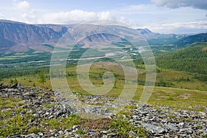 Sunny day in mountains of Polar Ural. View of the valley of the Sob river